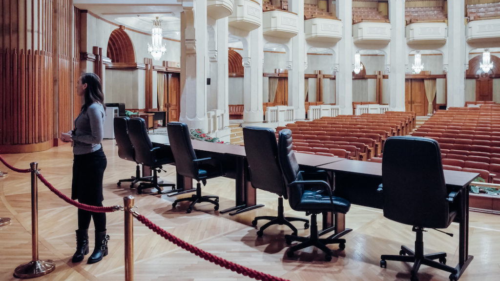 One of the rooms and the tour guide Palace of the Parliament in Bucharest