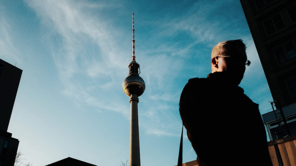 Man walking close to Fernsehturm TV Tower Alexanderplatz
