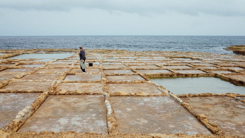A man working in the salt pans at Gozo, Malta