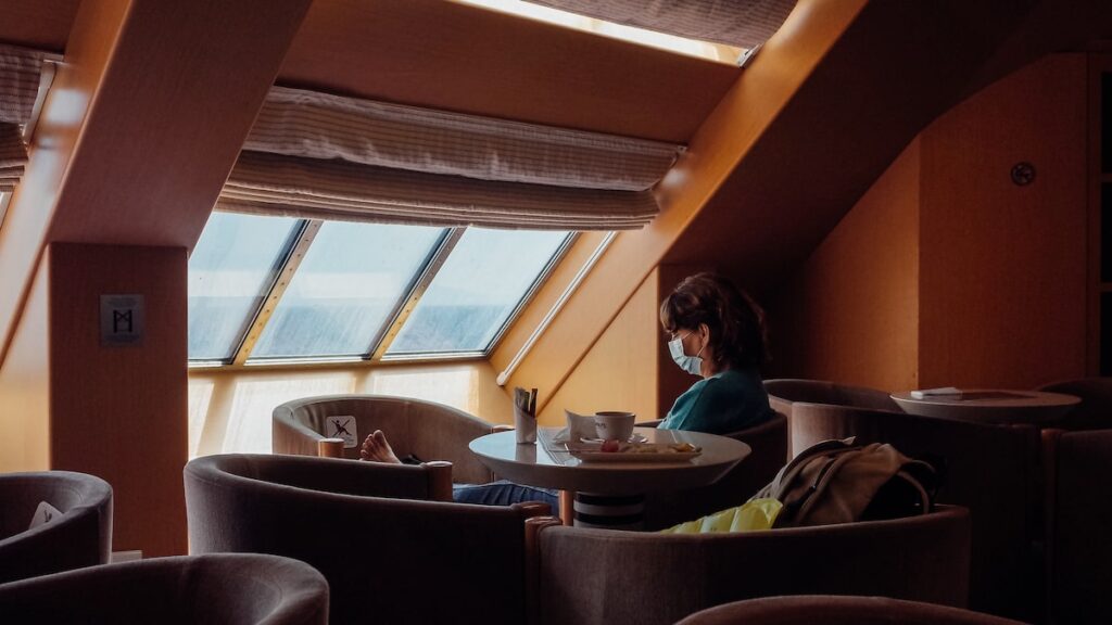 A woman on a business class seat on a Greek ferry during the pandemic