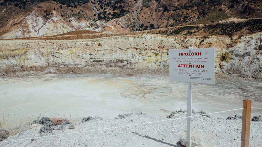 A sign at the entrance of the Nisyros volcano asking the visitor to be careful while descending to the crater Stefanos