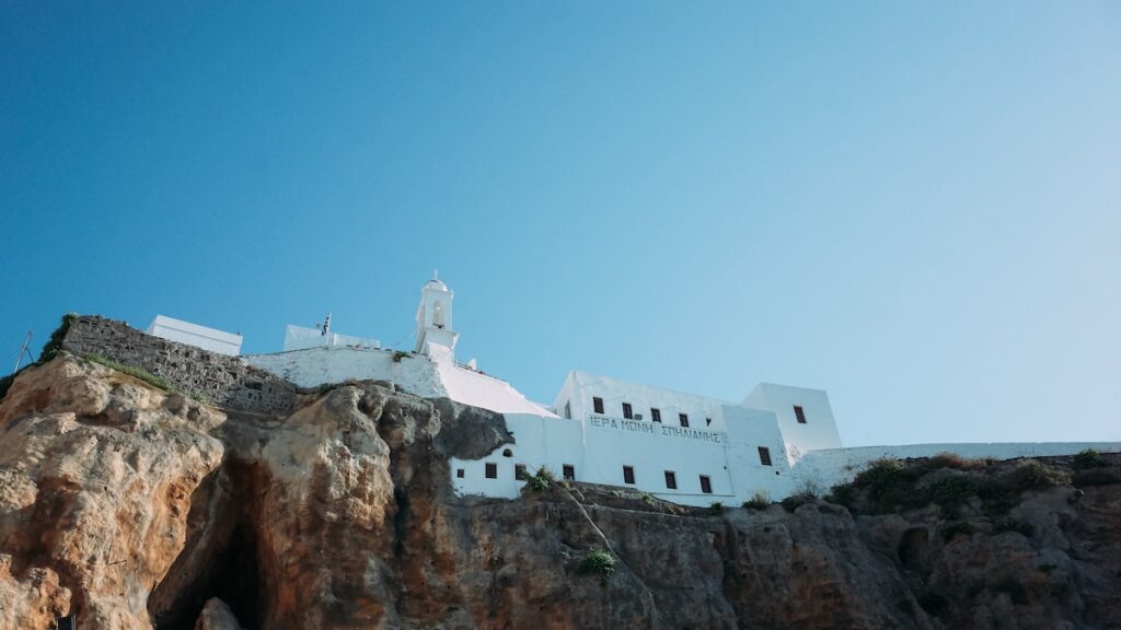 A photo of Panagia Spiliani, a monastery hanging on the rock and overlooking Nisyros, Greece