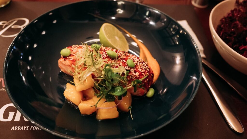 An image showing a dish of salmon with mango, a Riga food tip for your visit