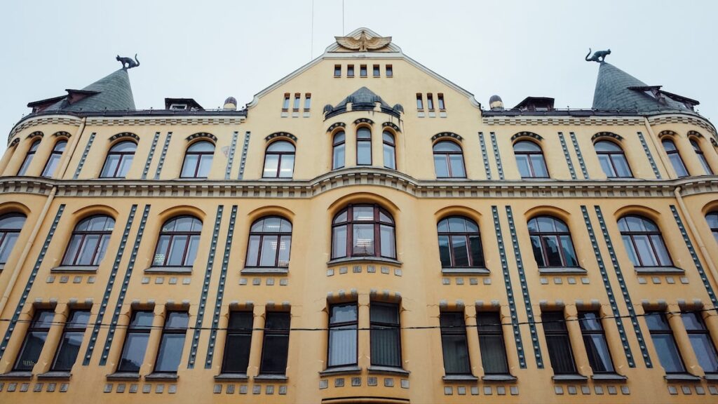 A photo of the Cat House in Riga, Latvia, featuring two sculpted cats on the rooftop