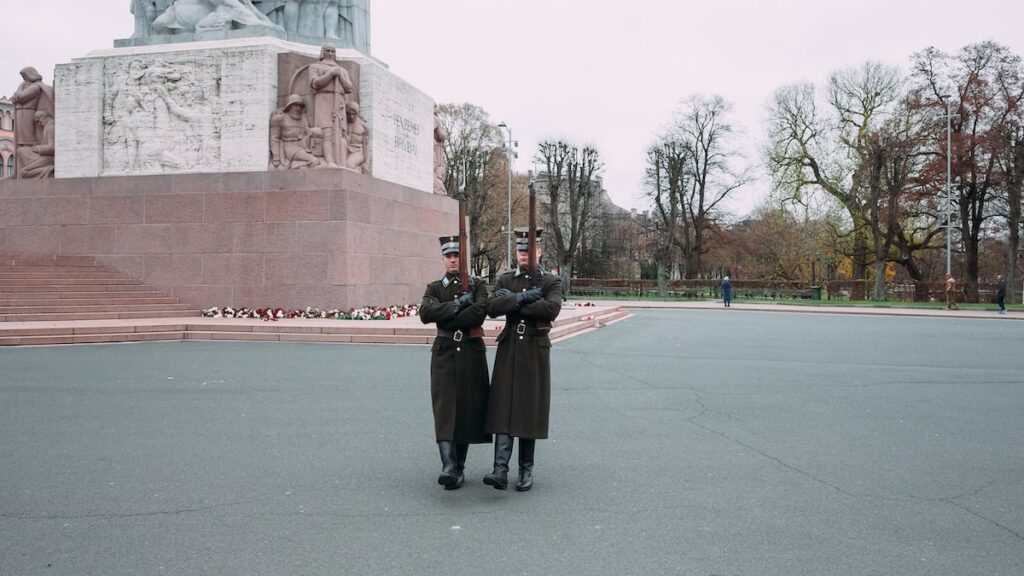 Two armed soldiers marching in front of the Freedom Monument in Riga on the occasion of the Latvia Independence Day celebration