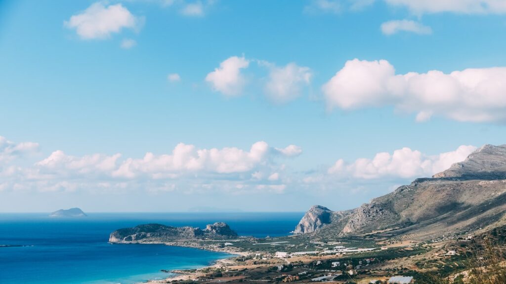 A panoramic photo of Falasarna beach in Crete. Cover image for the article about how to get from Athens to Crete, written by George Pavlopoulos, for the travel blog "Letters to Barbara."