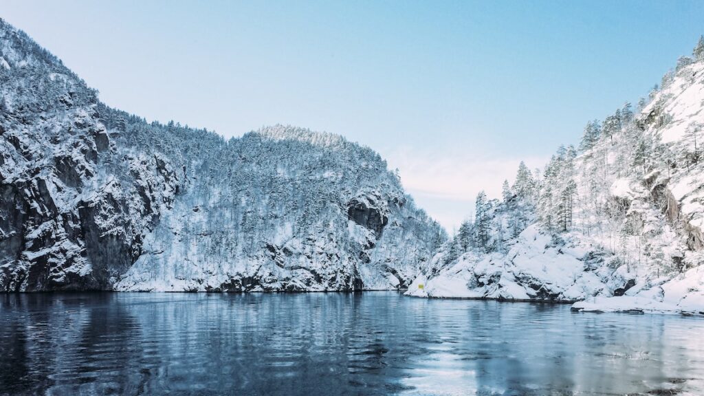 A photo of the snow covered mountains during a fjord cruise from Bergen to Mostraumen, one the best things to do in Bergen, Norway