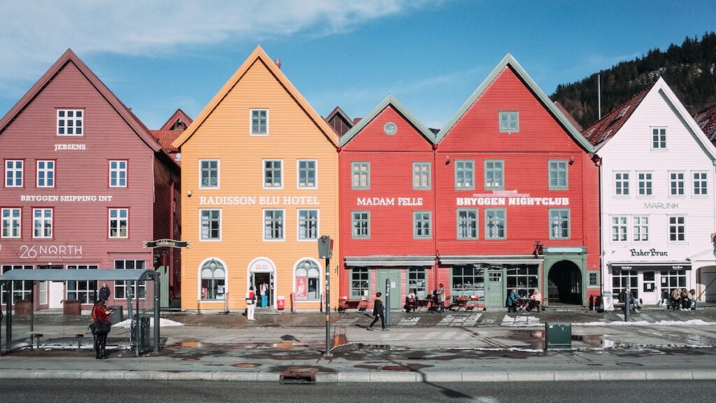The colorful wooden houses of Bryggen, in Bergen Norway. This is the cover photo of an article about the best things to do in Bergen written by George Pavlopoulos for the travel blog Letters to Barbara