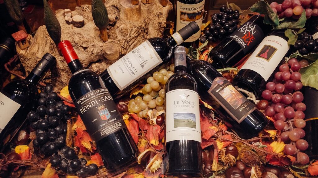 A photo showing Chianti wine bottles in Italy placed on grapes and other decorative elements