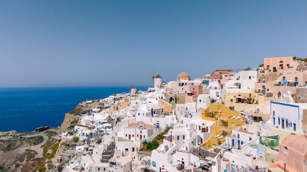An image of the iconic Oia village in Santorini, Greece. A must-see location if you arrive with a cruise ship and ready to embark in one or more Santorini shore excursions