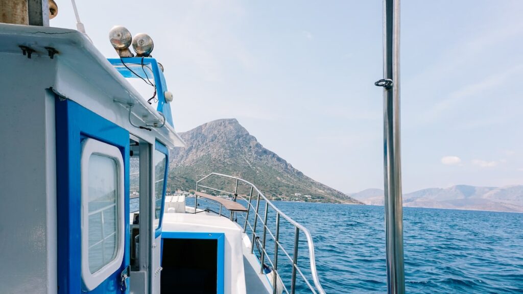 A photo showing a fishing boat sailing from Myrties, Kalymnos to the small Telendos island in the Dodecanese