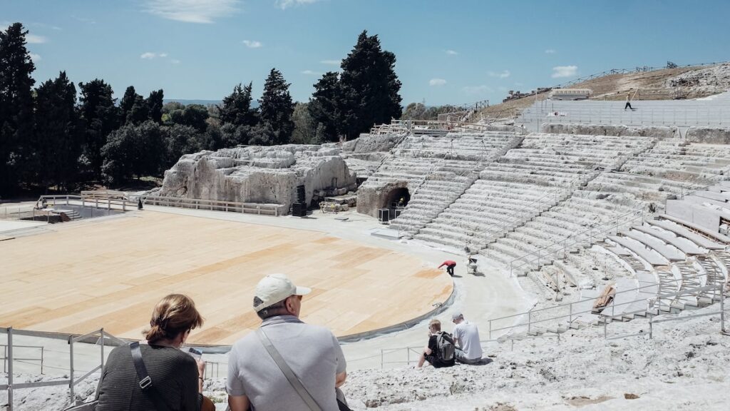 An image of the Greek Theater in Syracuse, Italy. The best Syracuse tours include a visit to the theater.