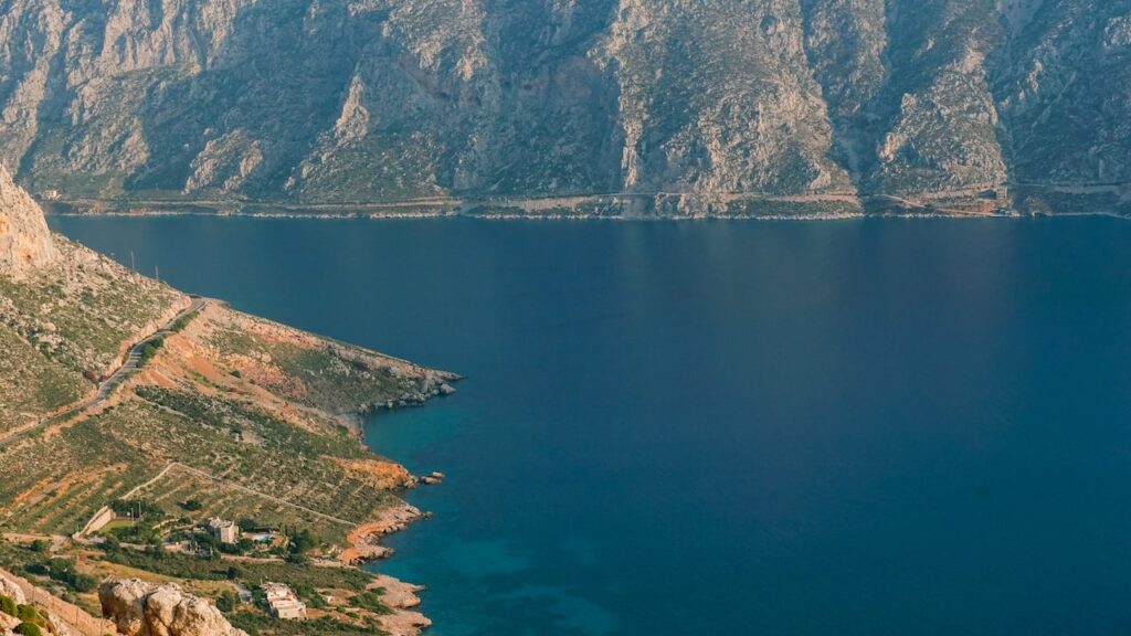 A photo showing the impressive mountains and of Kalymnos, Greece and the sea surrounding them.