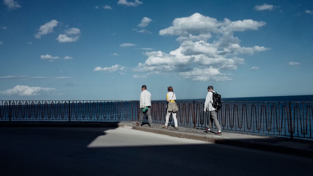 An image of three people walking in Syracuse, Italy. The best Syracuse walking tours always include walks around Ortygia