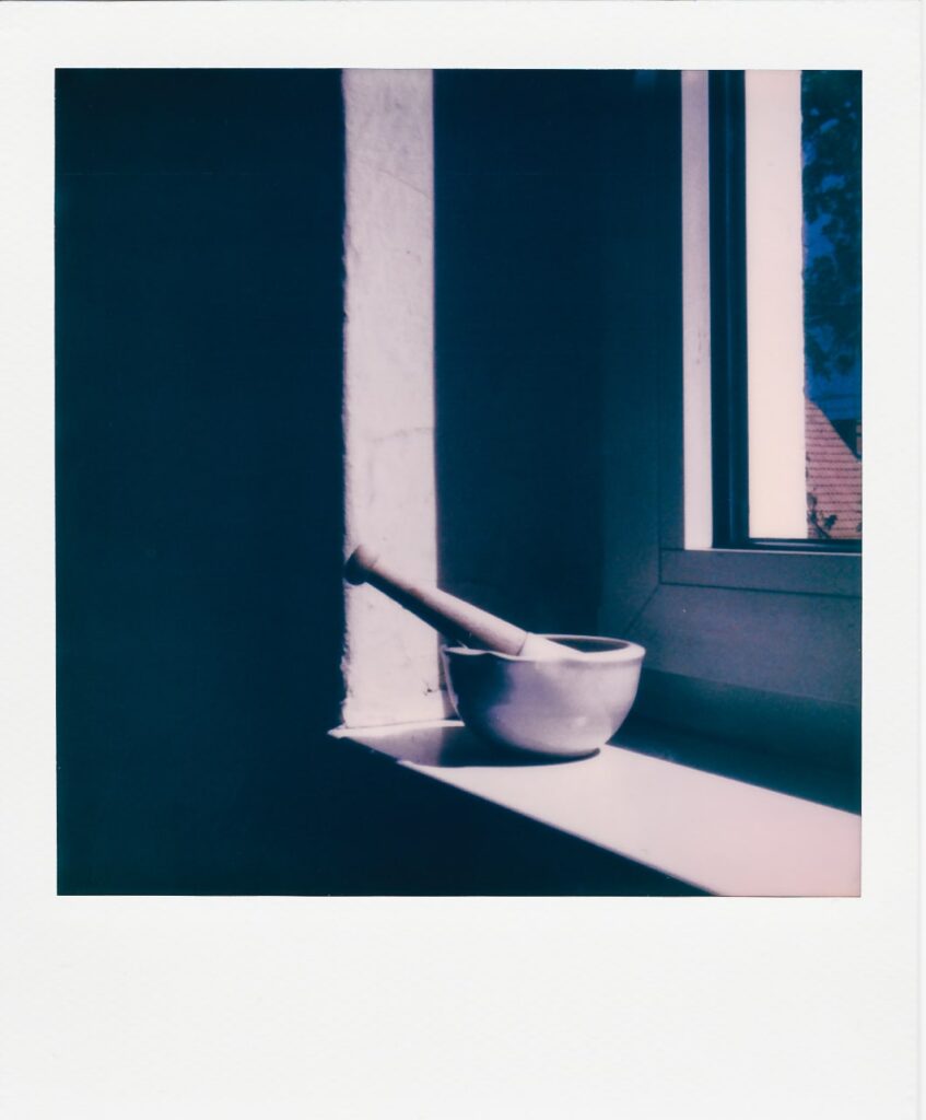 A polaroid of a bowl in front of a Berlin window, taken with the Polaroid OneStep Plus