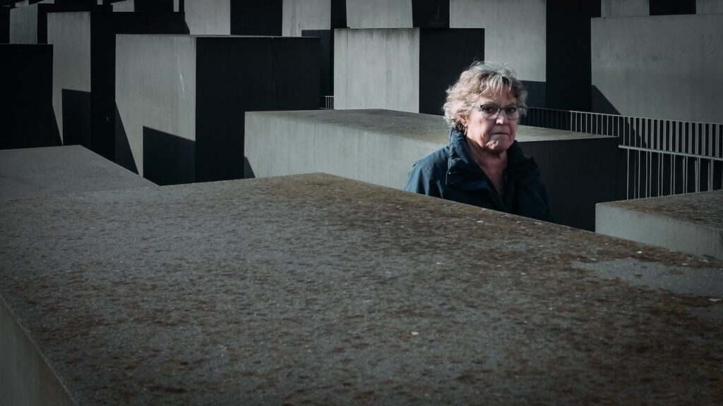 A photo of a woman walking at the Holocaust Memorial in Berlin, Germany. The image is taken with the Ricoh GR ii.