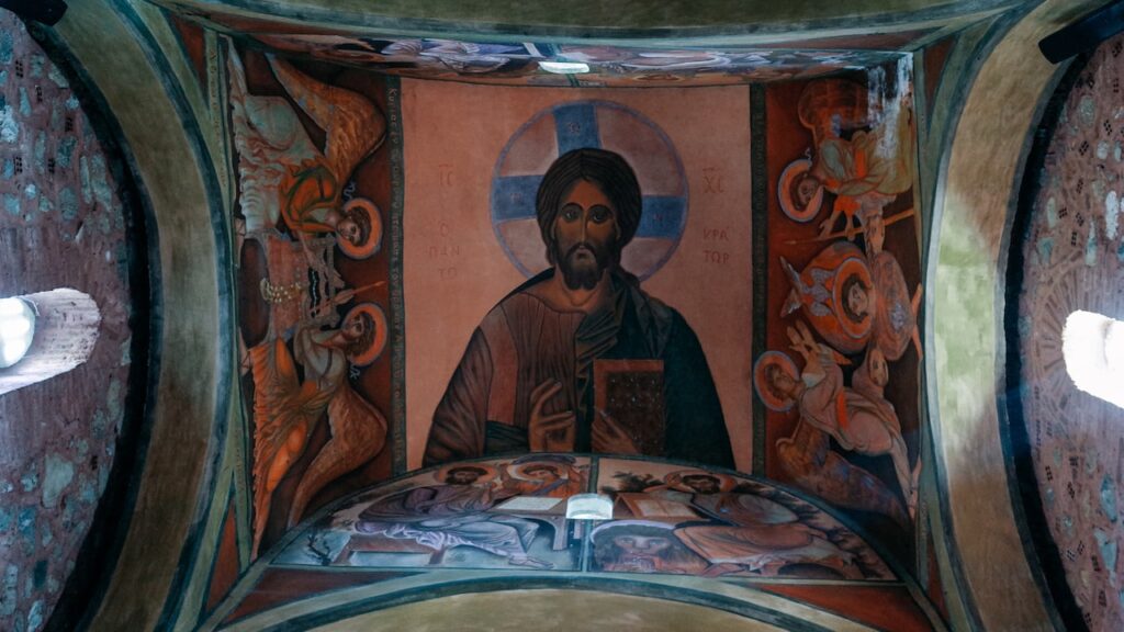 A photo of a Jesus Christ painting on the dome of Agia Fotini Mantineias Church in Greece.