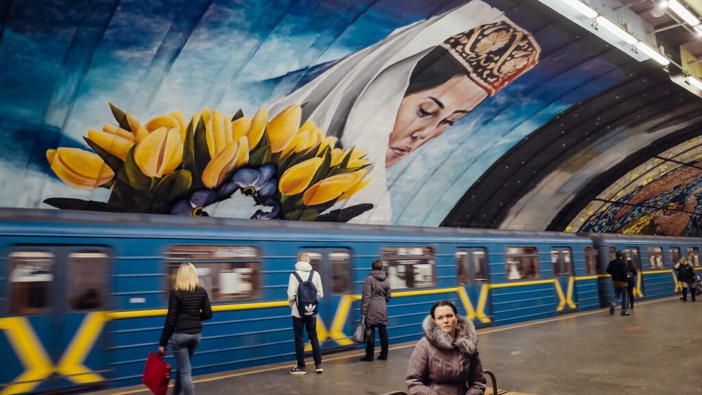 A photo of a woman in a metro station in Kyiv, Ukraine. The image is taken with the Ricoh GR ii.