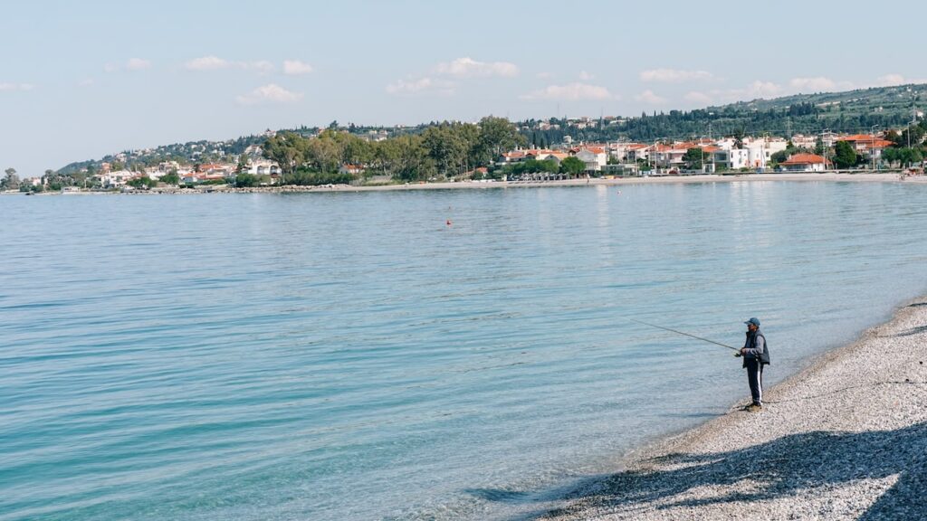 An image of a man fishing at Sykia Beach in Peloponnese.