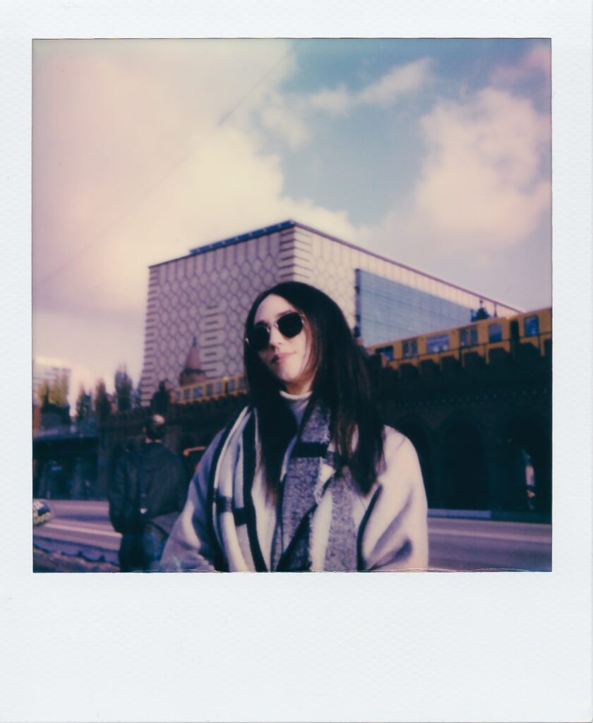 A polaroid of Marinela in front of the Oberbaum Bridge in Berlin, Germany, taken with the Polaroid OneStep+