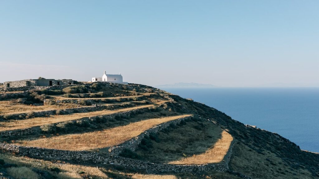 A photo of a church in a slope in front of the sea in Folegandros, Greece.
