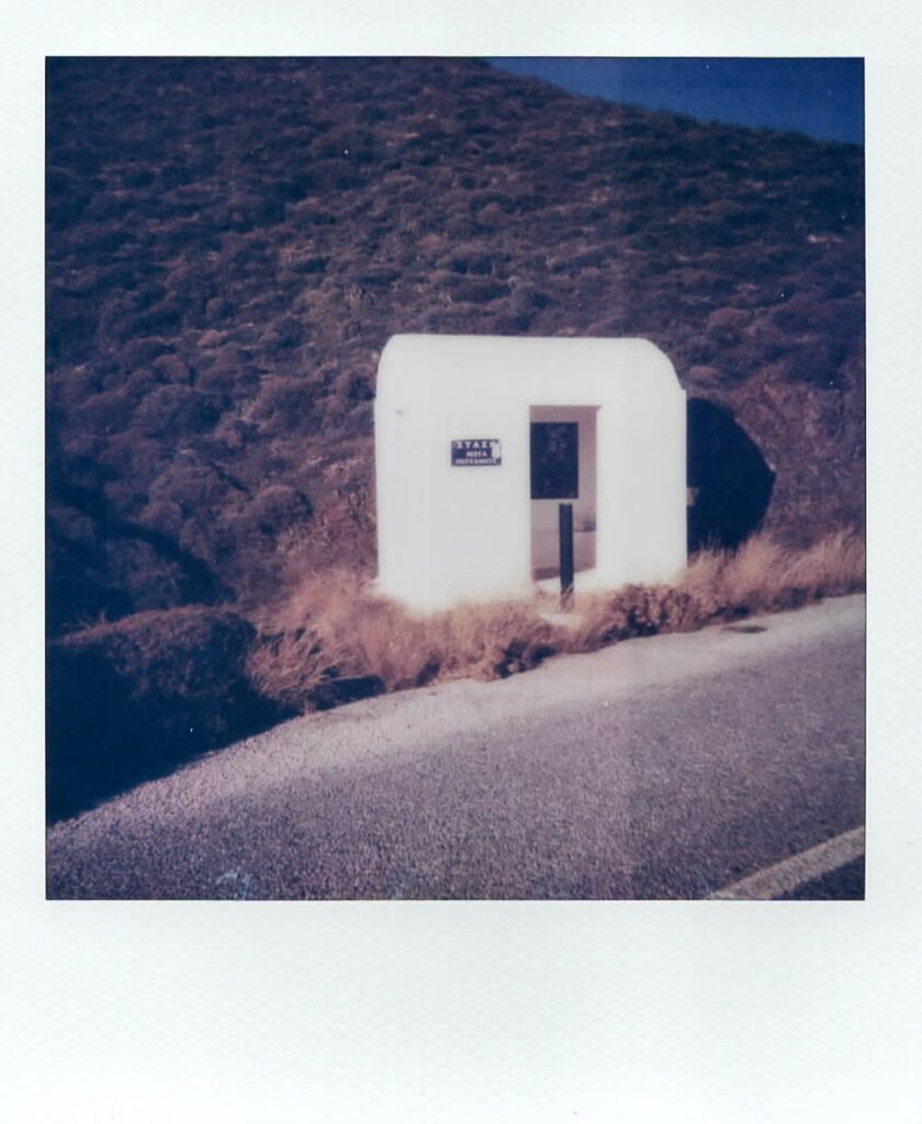 A polaroid photo showing a typical bus stop in the remote island of Anafi in Greece. The image is taken with the Polaroid Impulse AF.