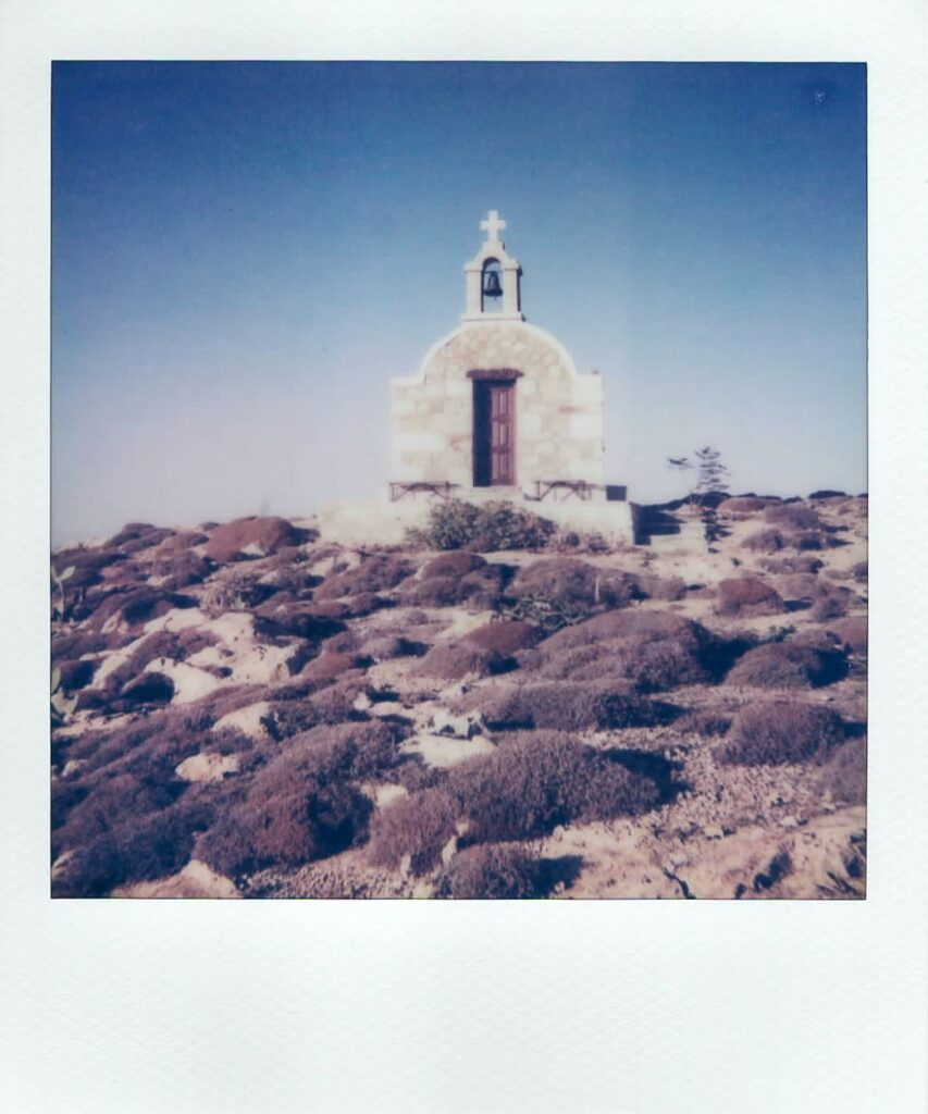 A polaroid showing one of the my favorite Anafi moments, the small church close to the Lower Monastery on the monolith's side. The photo is taken with the vintage Polaroid Impulse AF.