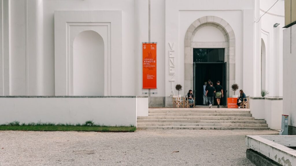 A photo from the Venice Architecture Biennale 2023 showing people entering the Venezia pavilion.