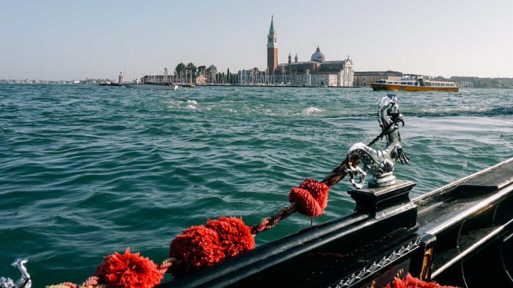 A photo showing the ornaments of a Venetian Gondola and the island of San Giorgio Maggiore in the background