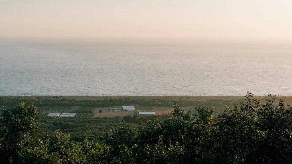 A photo showing a distant view of Zacharo Beach during sunset.