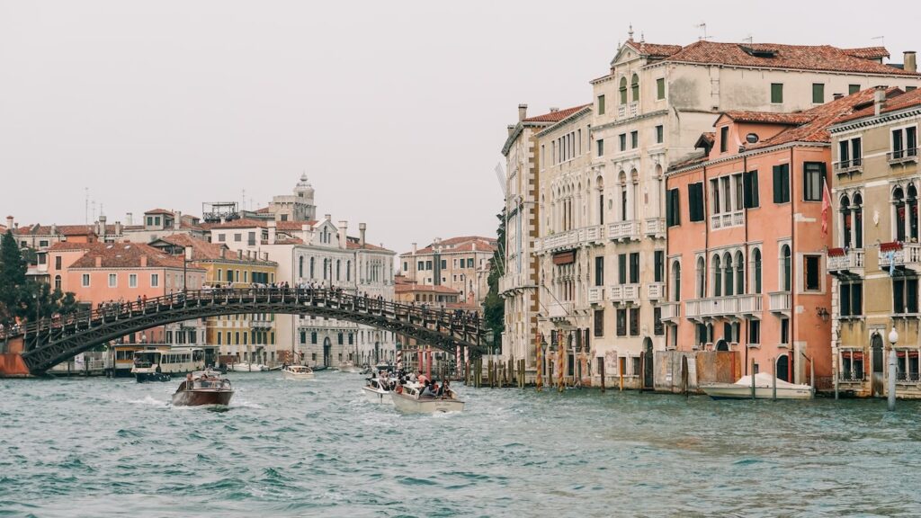 A photo of the Ponte Dell'Accademia on the Grand Canal of Venice, Italy, taken from the Guggenheim Collection museum. The image serves as the cover photo about an article for the Ponte Dell' Accademia written by George Pavlopoulos for the travel blog Letters to Barbara
