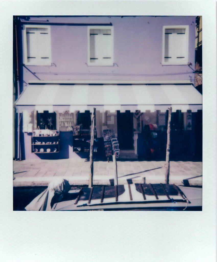 A polaroid of a purple house in Burano, Italy, taken with the Polaroid Impulse AF