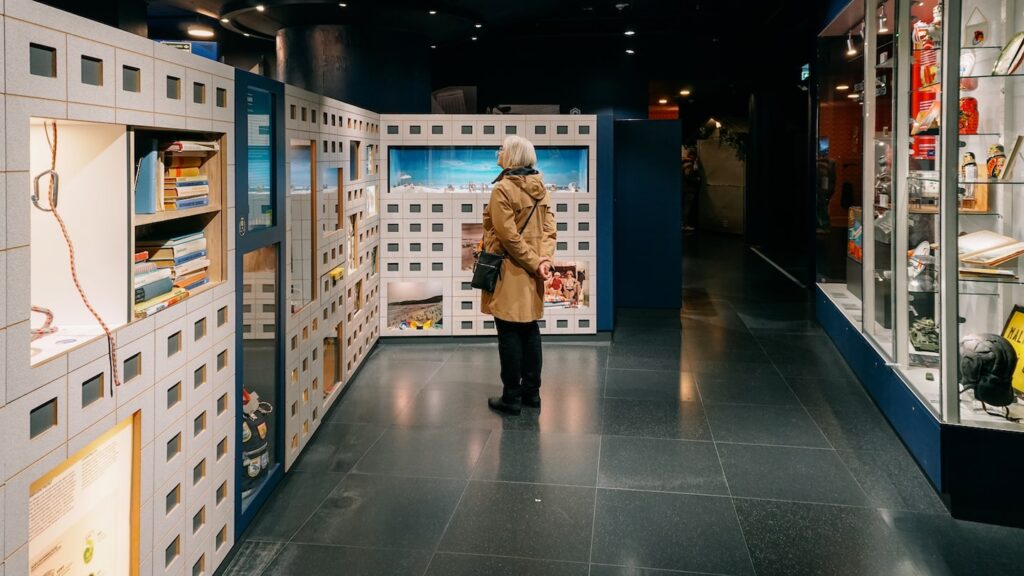 A photo of a woman reading informational material at the DDR Museum in Berlin