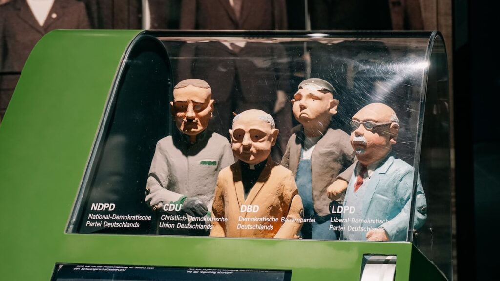 A photo showing figurines of the leaders of NDPD, CDU, DBD and LDPD, the political parties active during the Cold War in Germany
