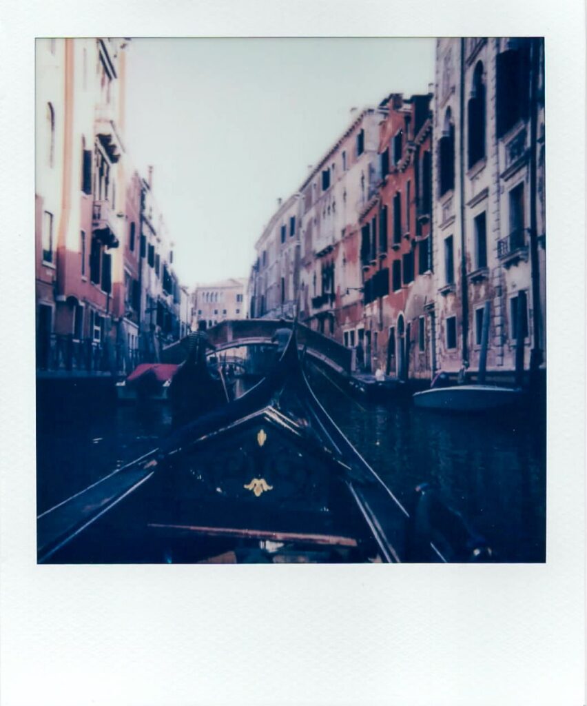 A polaroid showing the view of a Venice canal as seen from a gondola, taken with the Polaroid Impulse AF