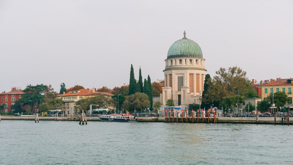 A photo of the Tempio Votivo Church in Lido and the coastline of the island. The image serves as the cover photo of an article about the best things to do in Lido, Venice, written by George Pavlopoulos for the travel blog Letters to Barbara