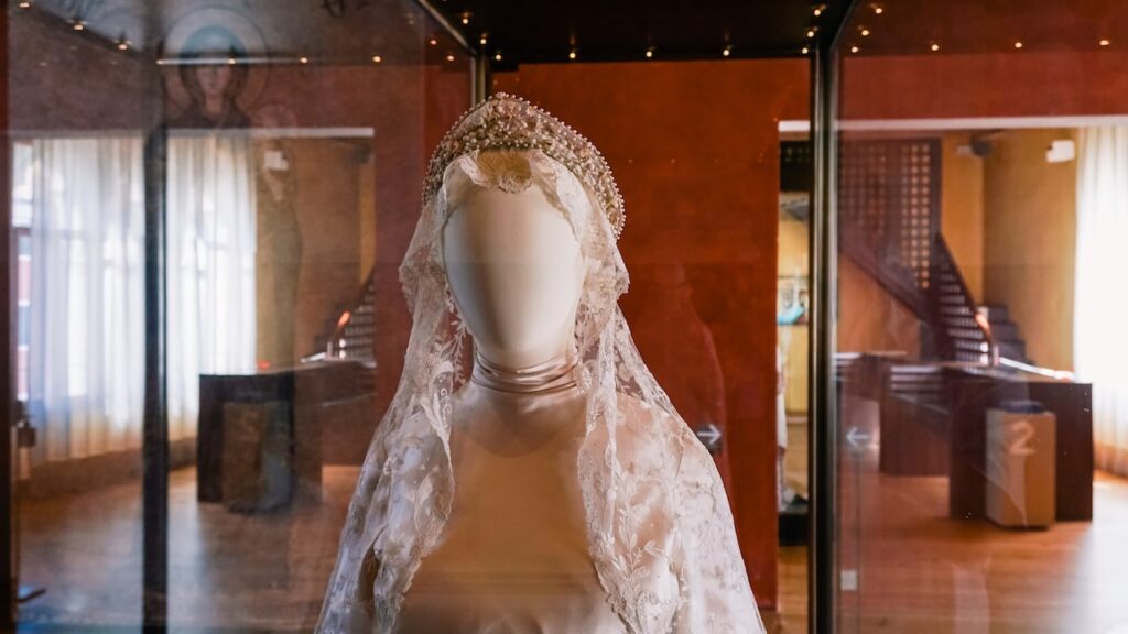 A photo showing the interior of Museo del Merletto in Burano, Italy, featuring a doll dressed in traditional Burano lace