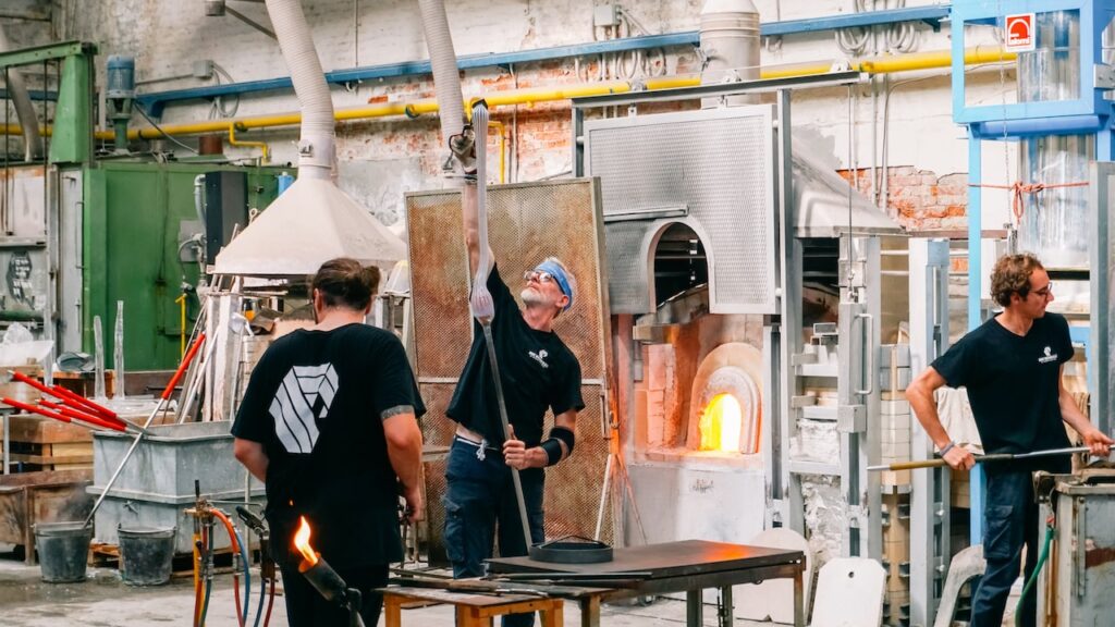 People working on glassmaking at a Murano glass factory in Italy