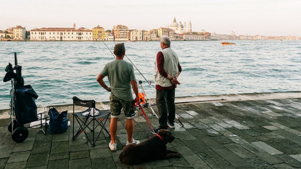 Two men fishing in Giudecca Island Venice