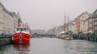 The port of Nyhavn. The image serves as the cover photo about an article for a Copenhagen Canal Tour written by George Pavlopoulos for the travel blog Letters to Barbara