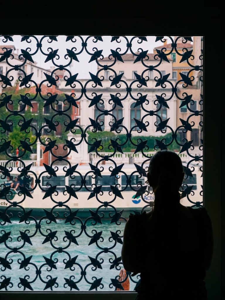 A woman looking out of the window at the Peggy Guggenheim Collection in Venice Italy
