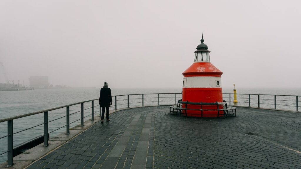 A lighthouse in Copenhagen and Barbara walking next to it