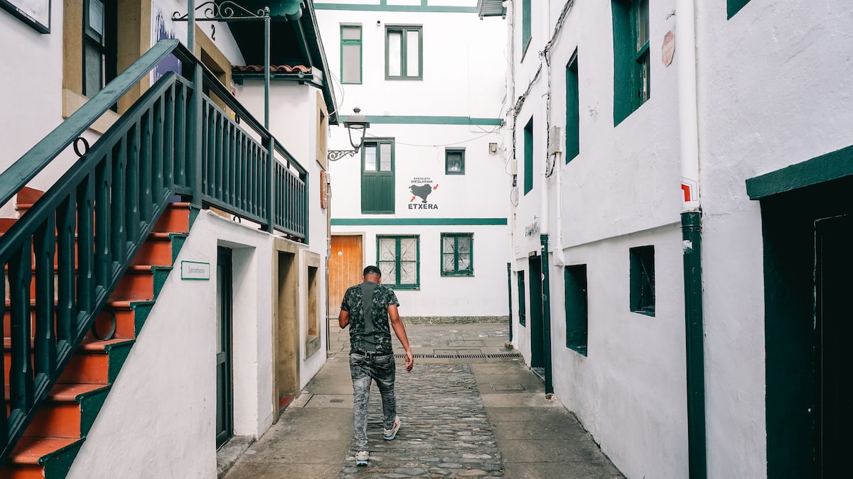 A man walking at the Old Port of Algorta
