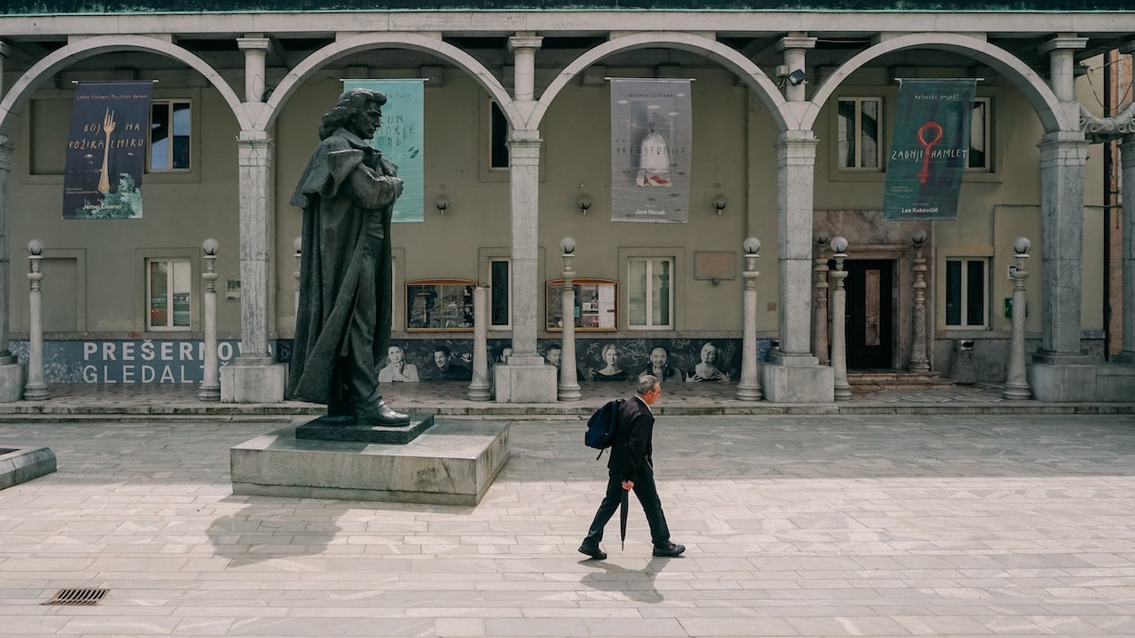 A man walking past Preseren's statue in Kranj, Slovenia, for the 2024 Year Review