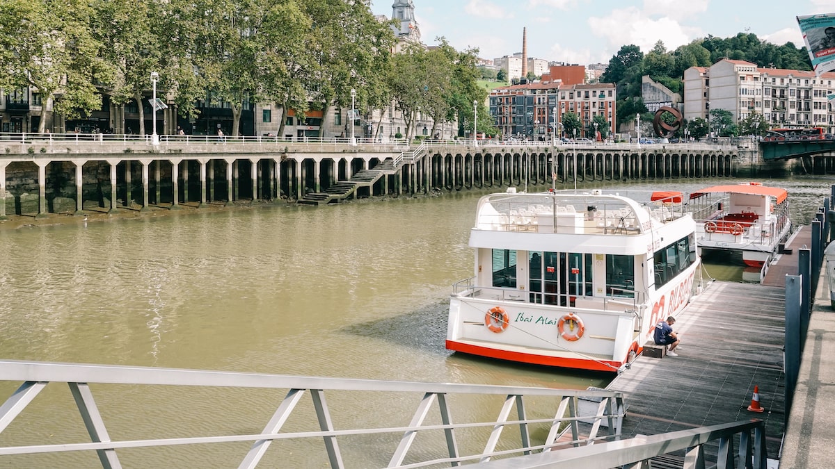 The Nervion River in Bilbao and two boats that offer Bilbao river tours.