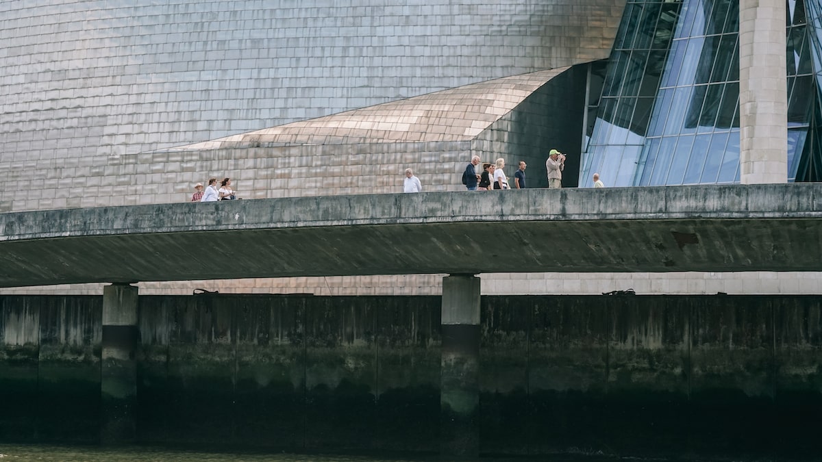 People walking in front of the Guggenheim Museum during a Bilbao boat tour