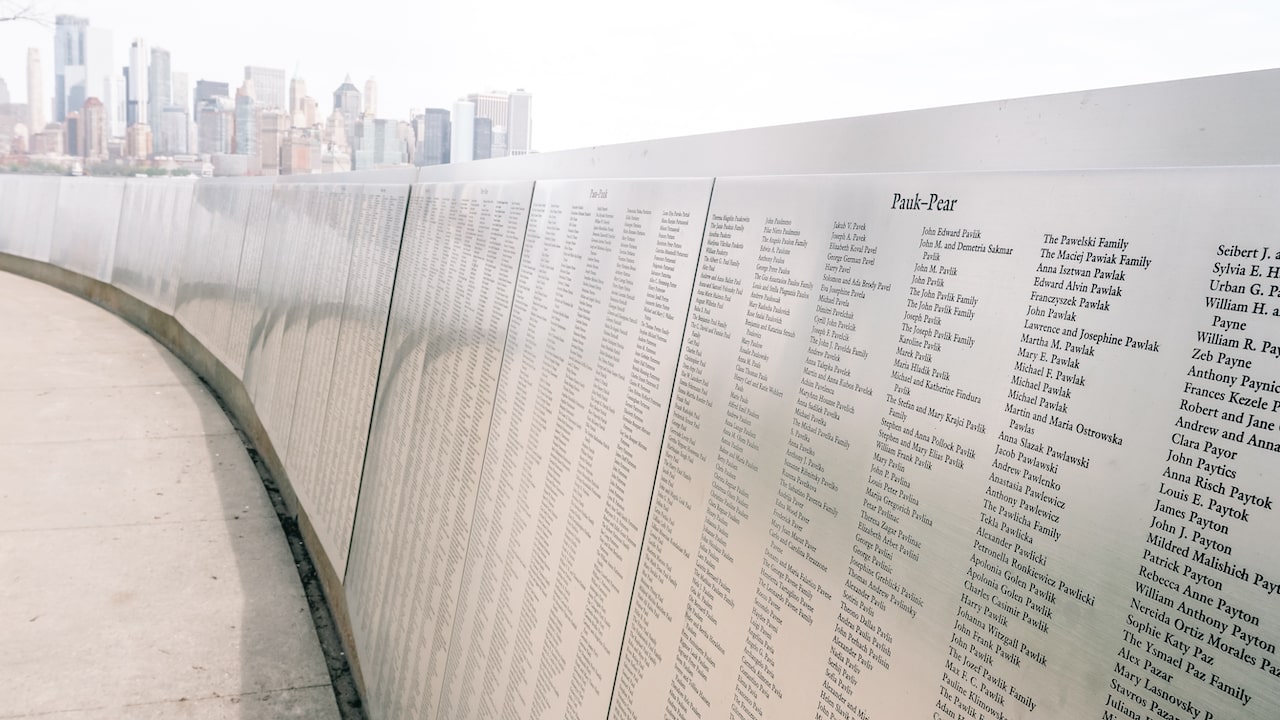 A wall with the names of people that immigrated to the United States and arrived at Ellis Island