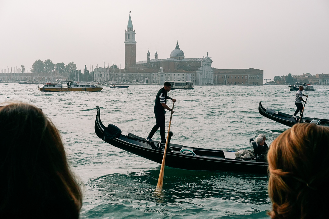 A gondolier rowing in the Grand Canal of Venice