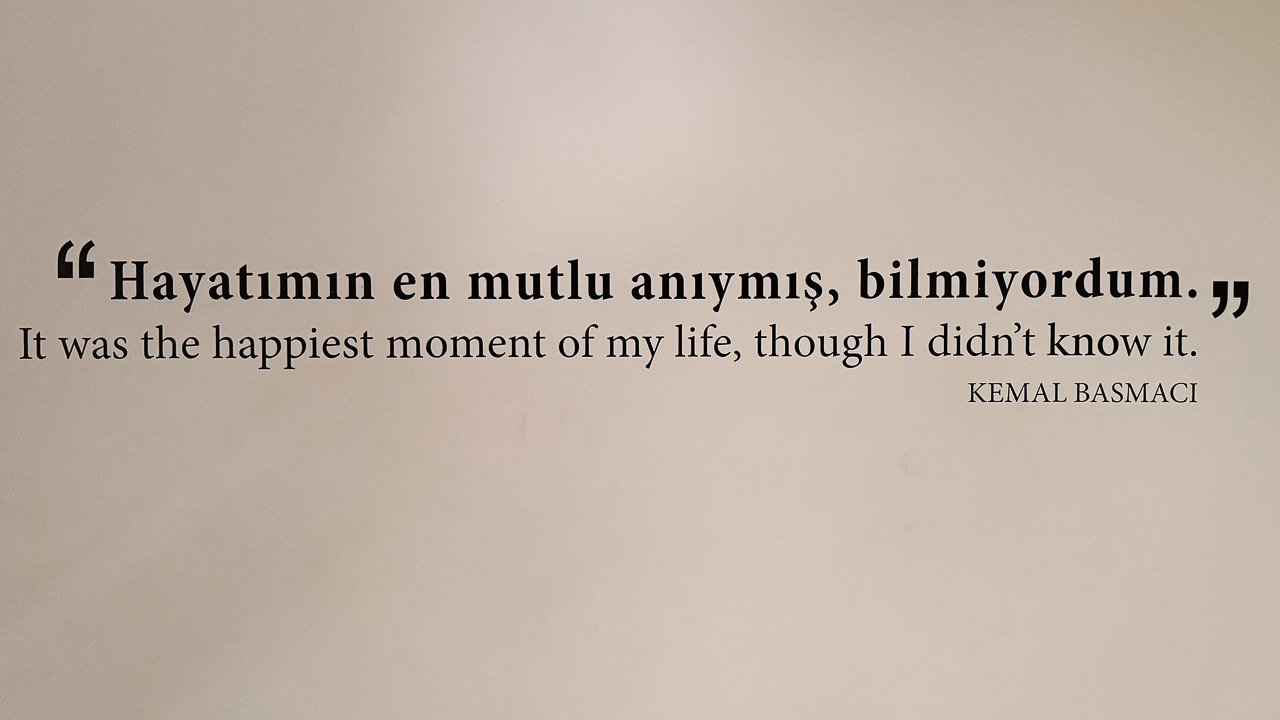 A quote from the Museum of Innocence novel by Orhan Pamuk that reads "It was the happiest moment of my life, though I didn't know it"