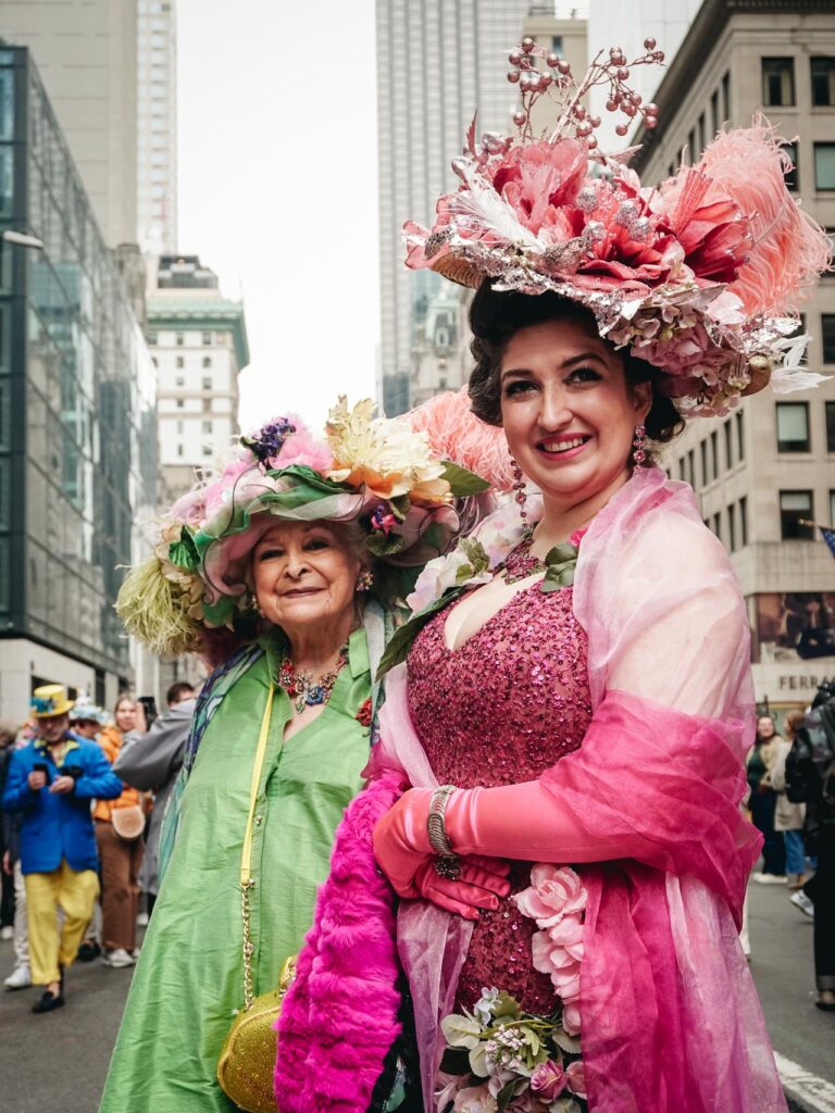 Two ladies posing for a street portrait during the New York Easter Parade Bonnet Festival 2026